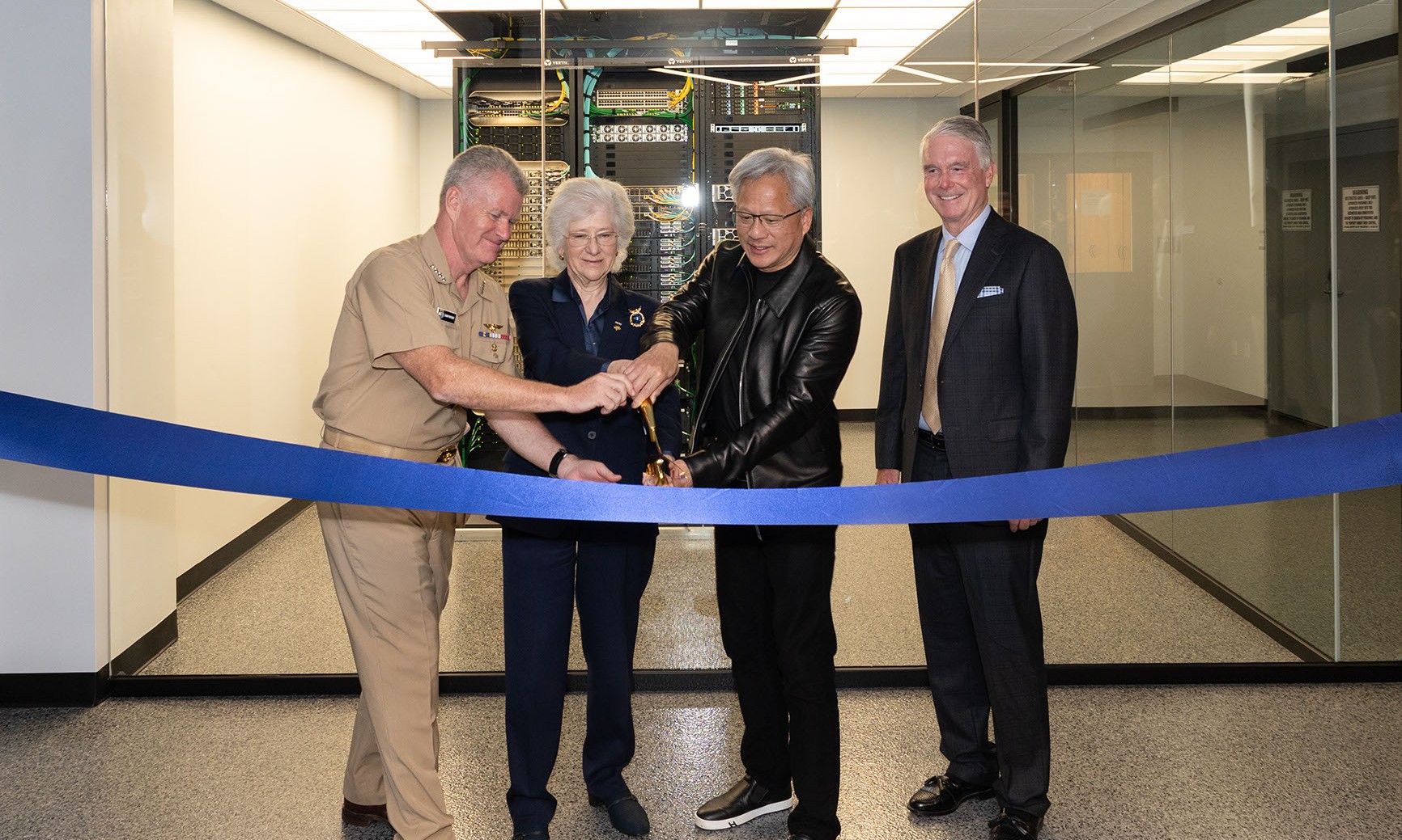 U.S. Navy Adm. Samuel J. Paparo, commander, U.S. Pacific Command; retired U.S. Navy Vice Adm. Ann E. Rondeau, president of the Naval Postgraduate School (NPS); Jensen Huang, founder and CEO of NVIDIA; and Hank Plain, board chair of the Naval Postgraduate School Foundation, cut a ribbon to mark the commissioning of the NVIDIA DGX GB300 AI supercomputer at NPS in Monterey, California, July 22, 2026.